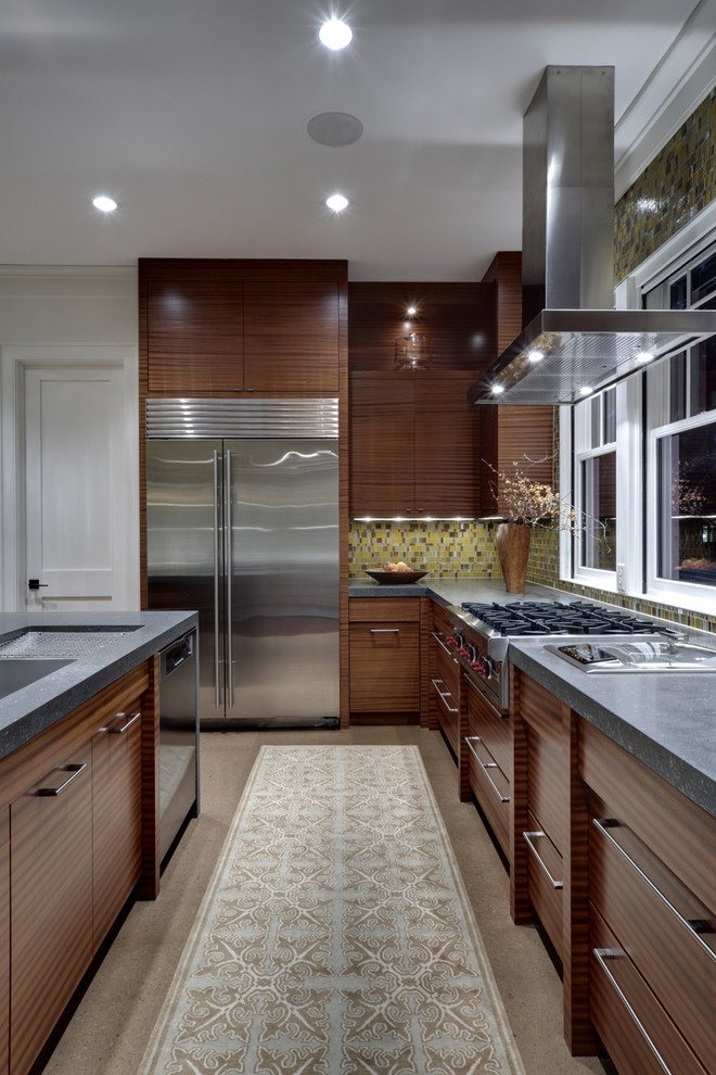 Trendy kitchen photo in Dallas with mosaic tile backsplash, green backsplash, flat-panel cabinets, dark wood cabinets, stainless steel appliances and soapstone countertops