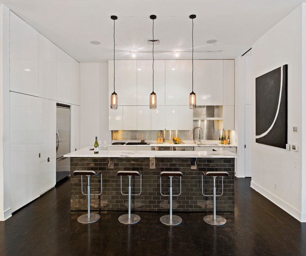 ニューヨークにあるコンテンポラリースタイルのおしゃれなII型キッチン (フラットパネル扉のキャビネット、白いキャビネット、メタリックのキッチンパネル) の写真