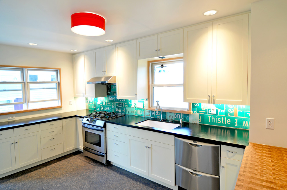 Inspiration for an industrial kitchen remodel in Seattle with stainless steel appliances