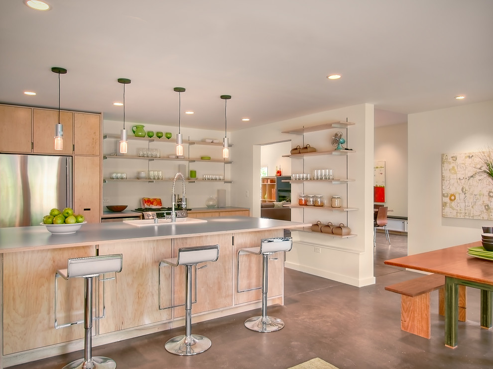 This is an example of a modern kitchen in Seattle with stainless steel appliances and open cabinets.