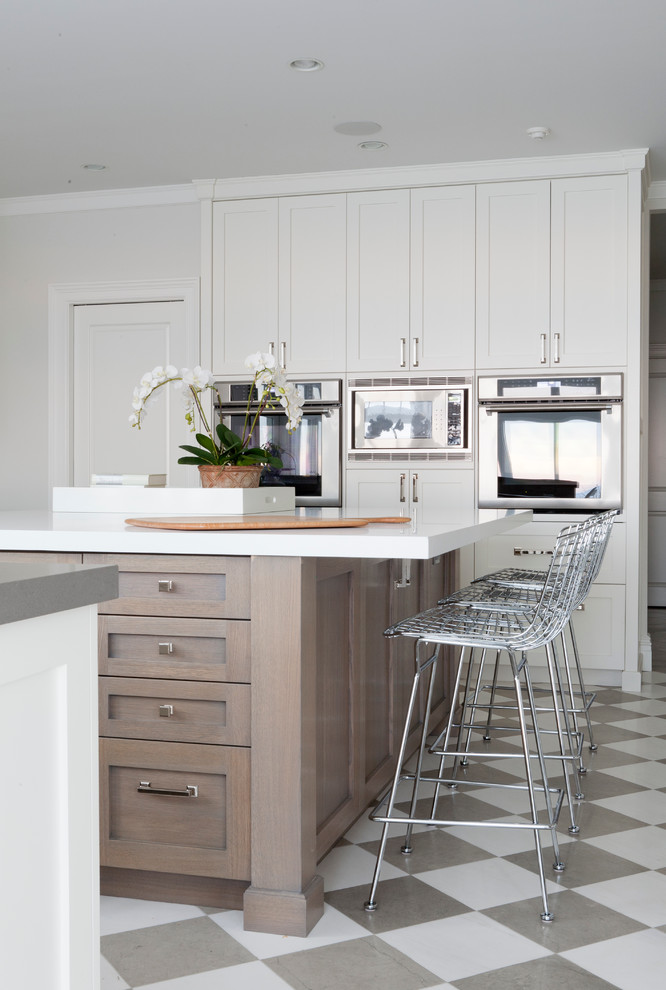 Inspiration for a traditional kitchen in New York with shaker cabinets, white cabinets, stainless steel appliances and an island.