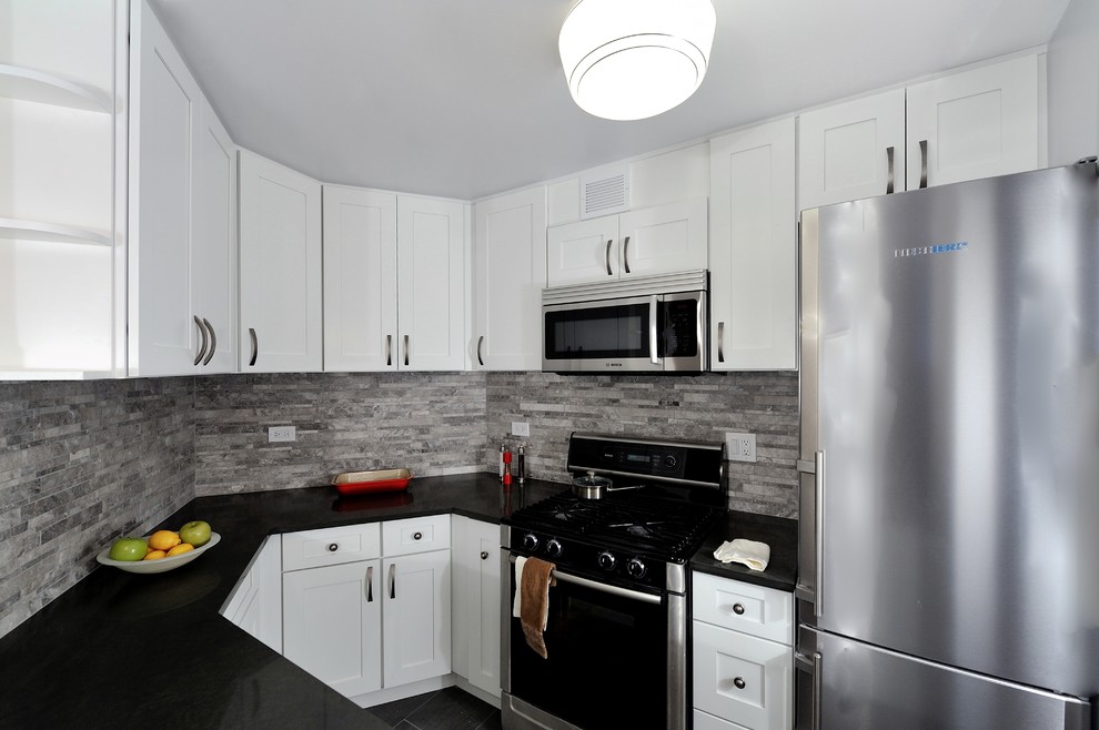 Small transitional u-shaped enclosed kitchen photo in New York with a single-bowl sink, raised-panel cabinets, white cabinets, granite countertops, gray backsplash, stone tile backsplash and stainless steel appliances