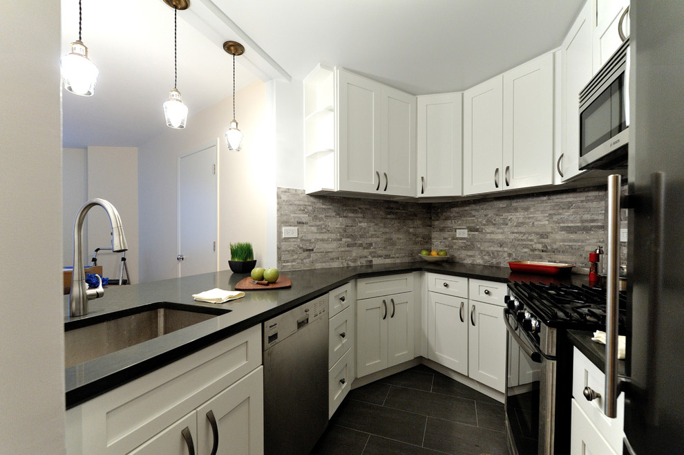 Enclosed kitchen - small transitional u-shaped enclosed kitchen idea in New York with a single-bowl sink, raised-panel cabinets, white cabinets, granite countertops, gray backsplash, stone tile backsplash and stainless steel appliances