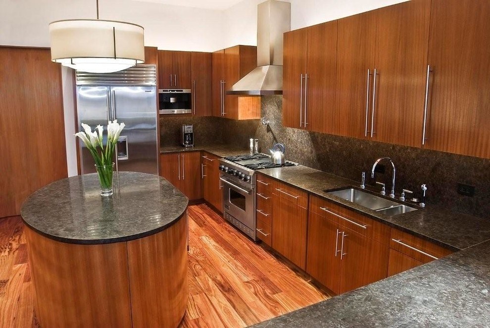 Example of a large transitional u-shaped medium tone wood floor kitchen pantry design in New York with a double-bowl sink, flat-panel cabinets, medium tone wood cabinets, granite countertops, black backsplash, stone slab backsplash, stainless steel appliances and an island