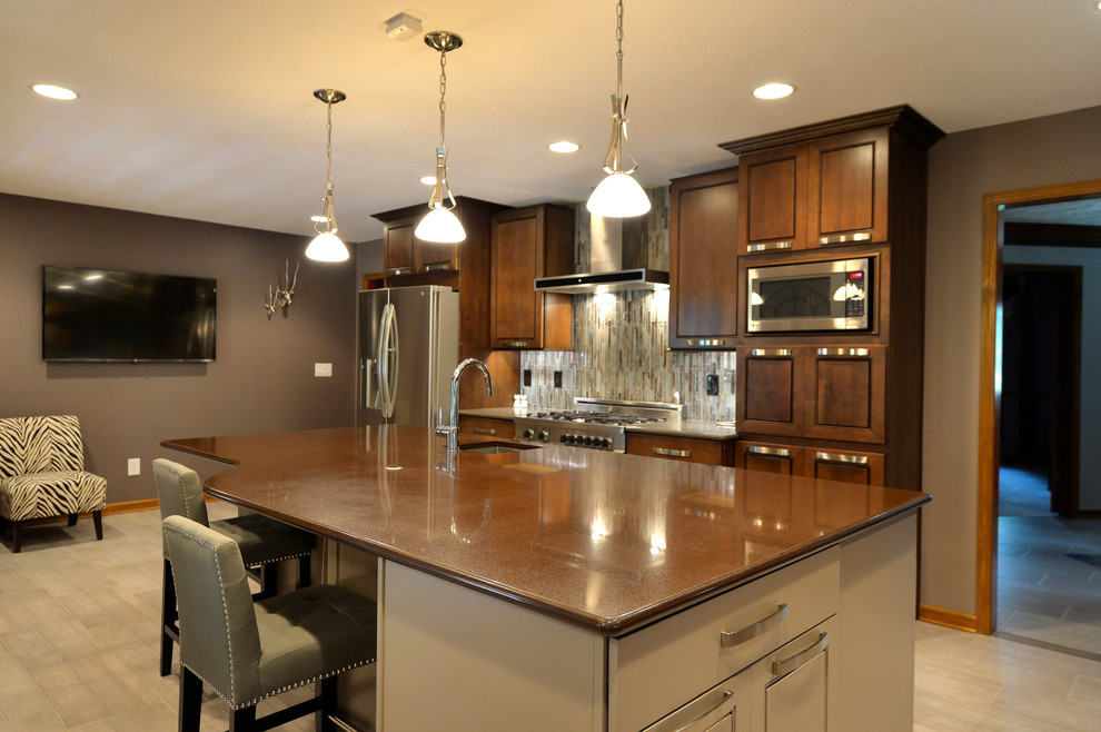 Example of a large transitional galley porcelain tile and beige floor eat-in kitchen design in Indianapolis with an undermount sink, raised-panel cabinets, dark wood cabinets, marble countertops, multicolored backsplash, matchstick tile backsplash, stainless steel appliances and an island