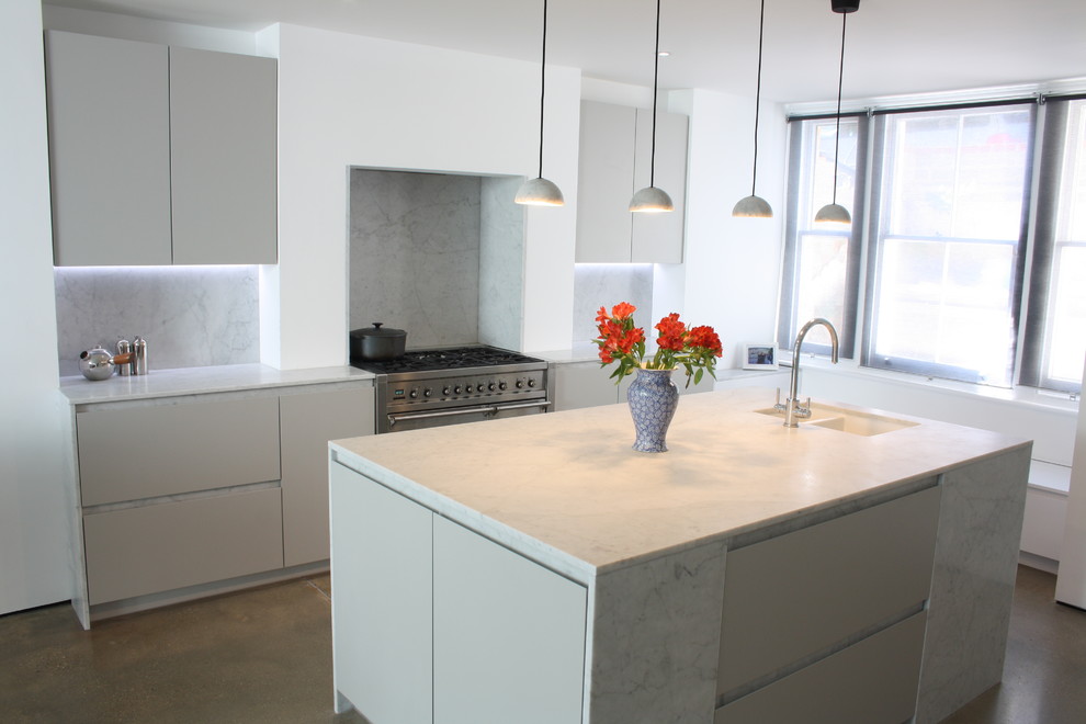 Inspiration for a medium sized contemporary open plan kitchen in London with a submerged sink, flat-panel cabinets, grey cabinets, marble worktops, grey splashback, marble splashback, stainless steel appliances, concrete flooring, an island and grey floors.