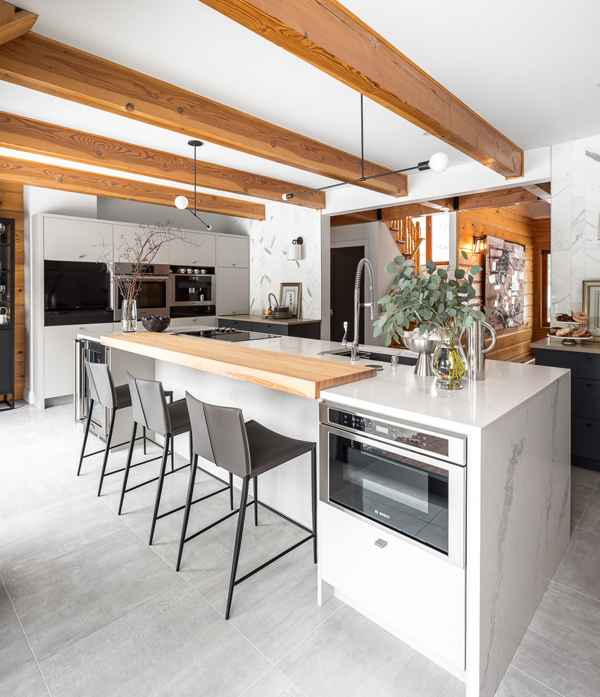 Moderne Küche mit Unterbauwaschbecken, flächenbündigen Schrankfronten, weißen Schränken und Küchengeräten aus Edelstahl in Ottawa