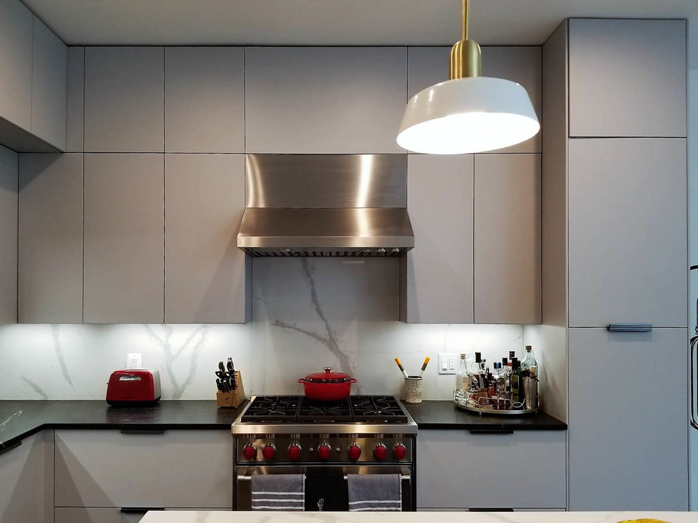 Inspiration for a medium sized modern l-shaped open plan kitchen in New York with a submerged sink, flat-panel cabinets, grey cabinets, engineered stone countertops, white splashback, stone slab splashback, stainless steel appliances, dark hardwood flooring, an island, brown floors and multicoloured worktops.