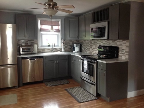 Gray RTA kitchen cabinets with stainless steel appliances, tile backsplash, and modern U-shaped layout