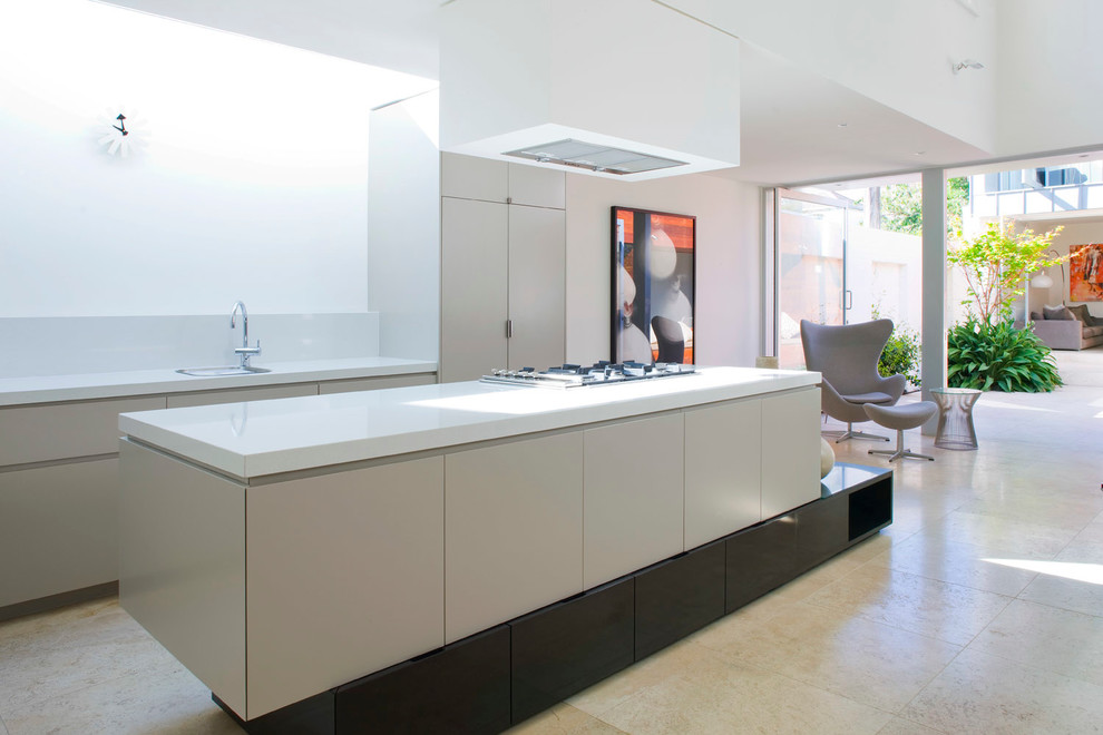 Photo of a contemporary galley kitchen in Melbourne with flat-panel cabinets, grey cabinets, white splashback and an island.