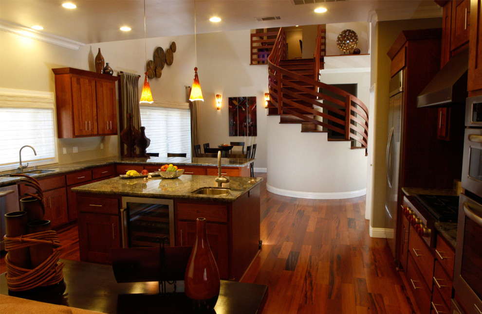 Example of a large trendy u-shaped medium tone wood floor eat-in kitchen design in San Francisco with an undermount sink, shaker cabinets, medium tone wood cabinets, granite countertops, stainless steel appliances and an island