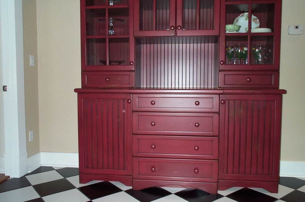 Example of a cottage eat-in kitchen design in Orlando with recessed-panel cabinets, red cabinets and wood countertops