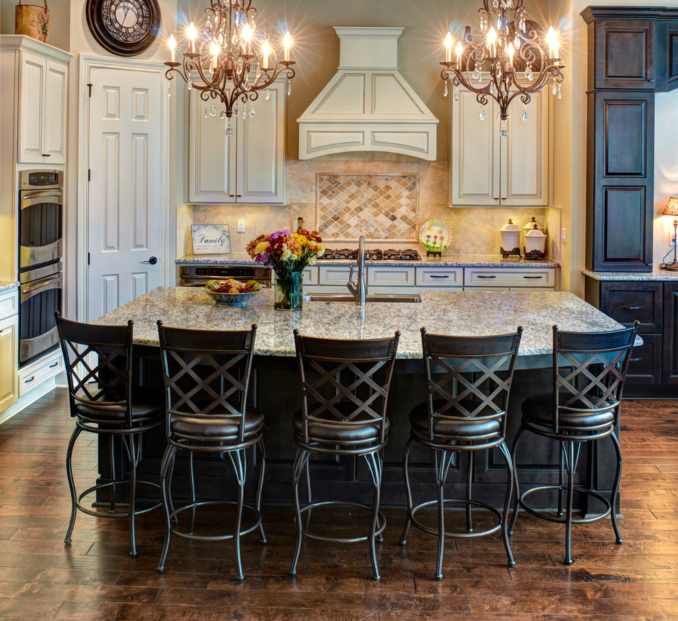 Classic kitchen in Jacksonville with raised-panel cabinets, a submerged sink, beige cabinets, beige splashback and stainless steel appliances.