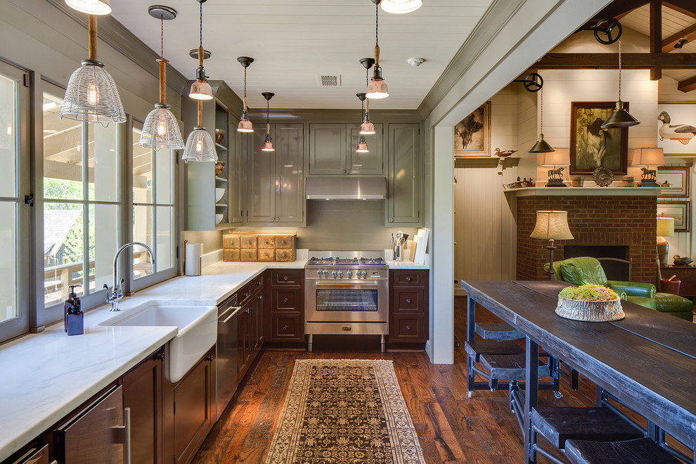 Example of a mid-sized farmhouse l-shaped dark wood floor and brown floor open concept kitchen design in Nashville with a farmhouse sink, recessed-panel cabinets, brown cabinets, stainless steel appliances and an island