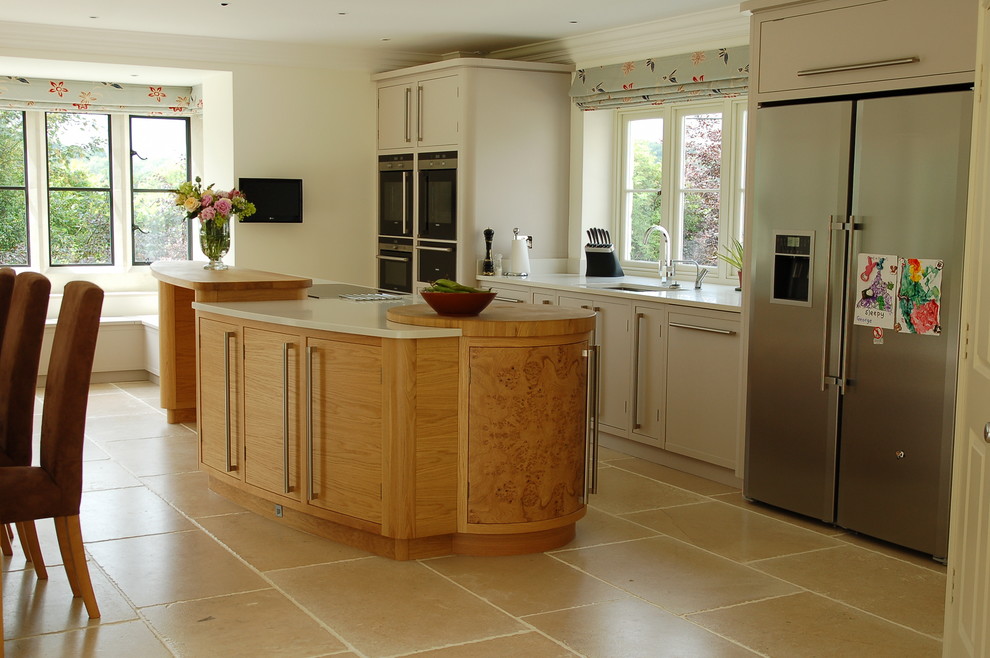 Exempel på ett mycket stort linjärt kök med öppen planlösning, med en nedsänkt diskho, beige skåp, träbänkskiva, rostfria vitvaror, klinkergolv i keramik och en köksö