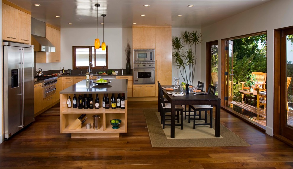 Enclosed kitchen - large traditional l-shaped medium tone wood floor enclosed kitchen idea in Los Angeles with an undermount sink, open cabinets, light wood cabinets, stainless steel countertops, window backsplash, stainless steel appliances and an island