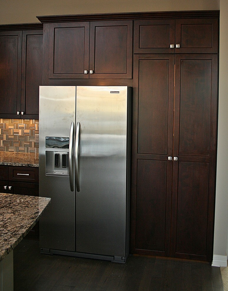 Photo of a traditional open plan kitchen in Omaha with recessed-panel cabinets.