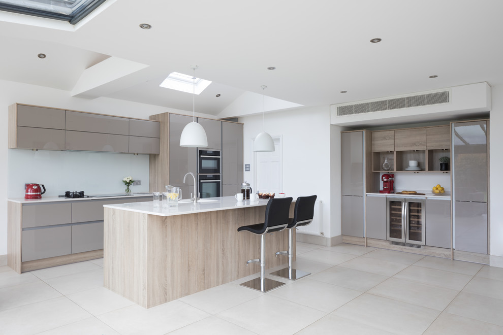 Inspiration for a contemporary kitchen in Other with flat-panel cabinets, beige cabinets, white splashback, an island, beige floors and white worktops.