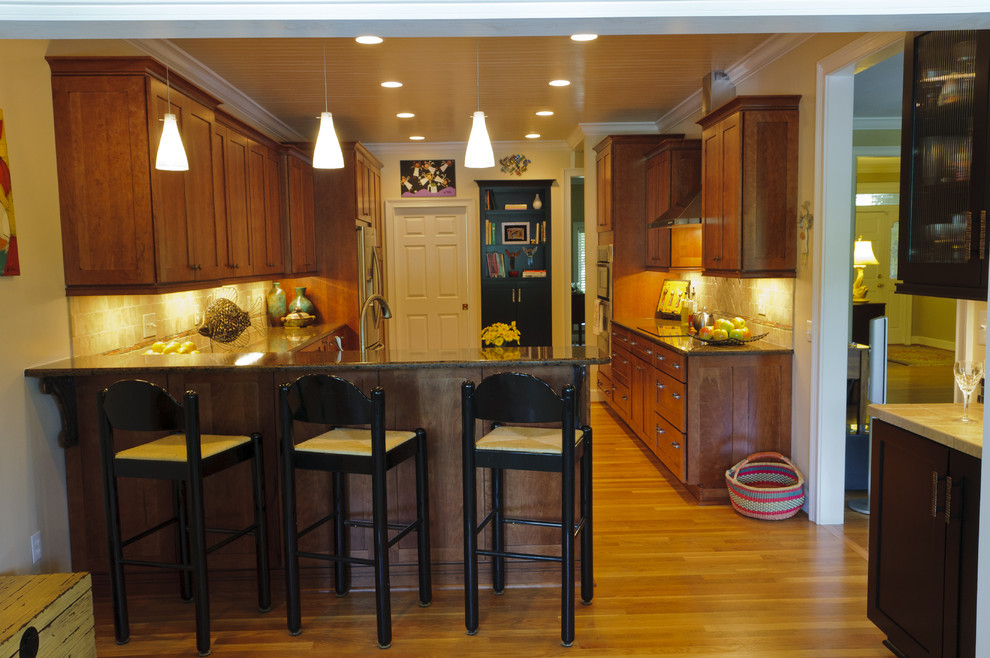 Example of a classic u-shaped kitchen design in Other with shaker cabinets, medium tone wood cabinets and beige backsplash