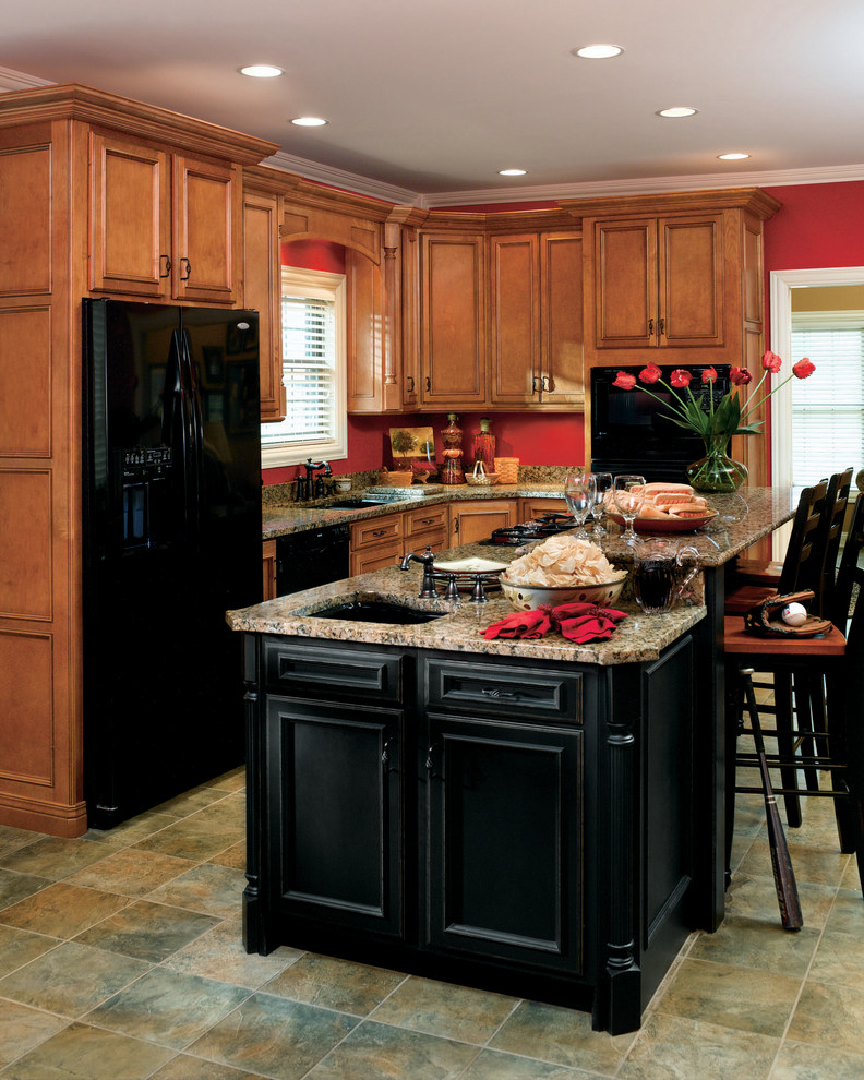 This is an example of a medium sized traditional l-shaped enclosed kitchen in Other with a submerged sink, recessed-panel cabinets, medium wood cabinets, granite worktops, black appliances, slate flooring, an island, green floors and beige worktops.