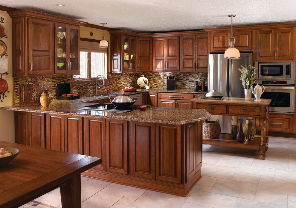 This is an example of a large classic u-shaped enclosed kitchen in Other with a double-bowl sink, raised-panel cabinets, dark wood cabinets, granite worktops, multi-coloured splashback, matchstick tiled splashback, stainless steel appliances, bamboo flooring, an island, beige floors and beige worktops.