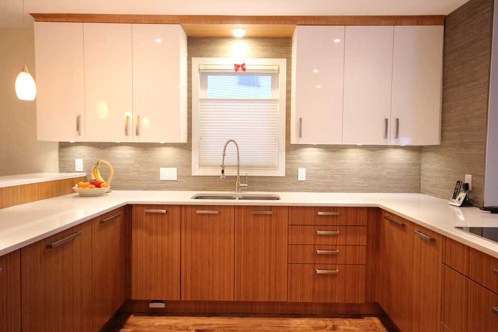 Example of a mid-sized trendy u-shaped medium tone wood floor open concept kitchen design in Ottawa with a drop-in sink, flat-panel cabinets, light wood cabinets, quartzite countertops, beige backsplash, ceramic backsplash, stainless steel appliances and no island