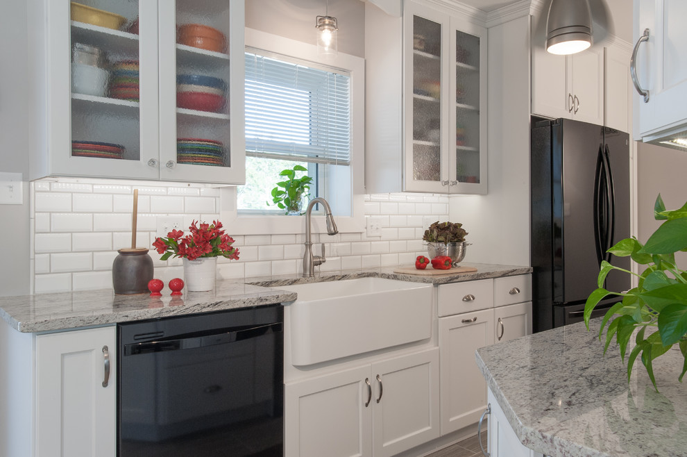 Example of a mid-sized transitional l-shaped porcelain tile eat-in kitchen design in St Louis with an integrated sink, shaker cabinets, white cabinets, granite countertops, yellow backsplash, subway tile backsplash, colored appliances and no island