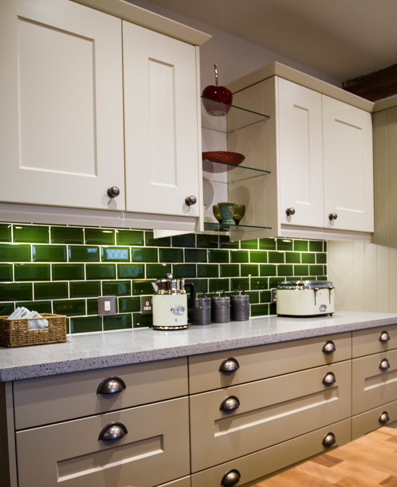 Design ideas for a medium sized classic kitchen/diner in Sussex with shaker cabinets, composite countertops, green splashback, vinyl flooring, an island, grey floors and metro tiled splashback.