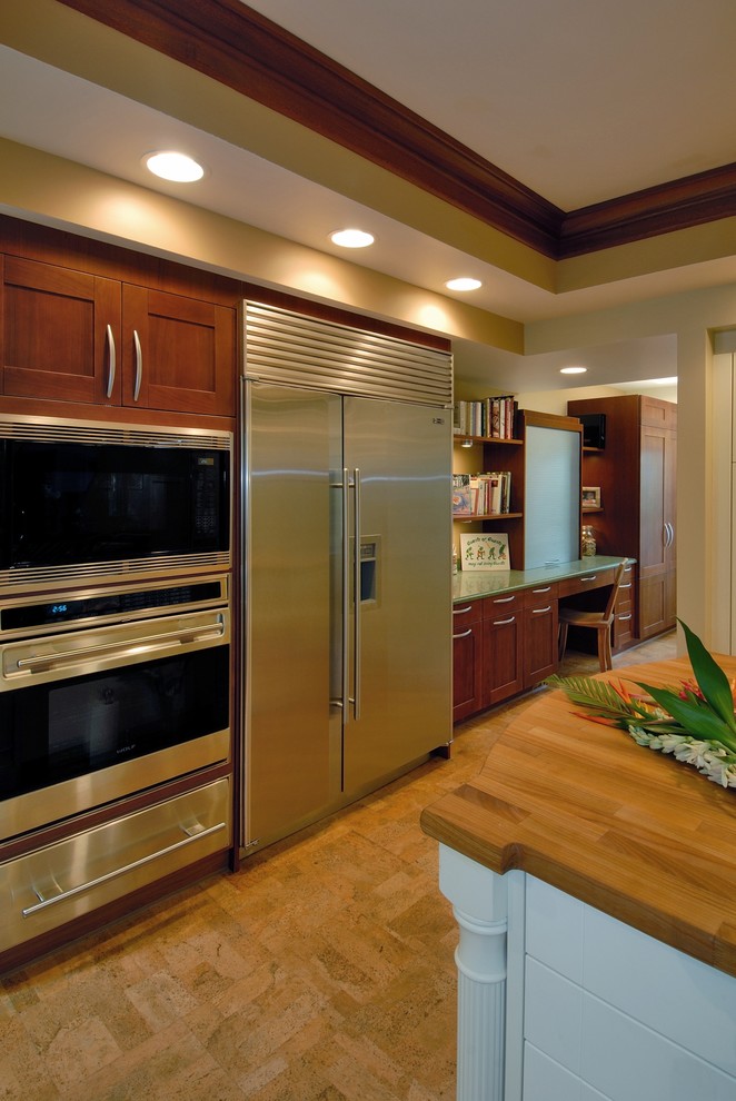 Example of an island style cork floor eat-in kitchen design in Hawaii with stainless steel appliances, wood countertops and medium tone wood cabinets