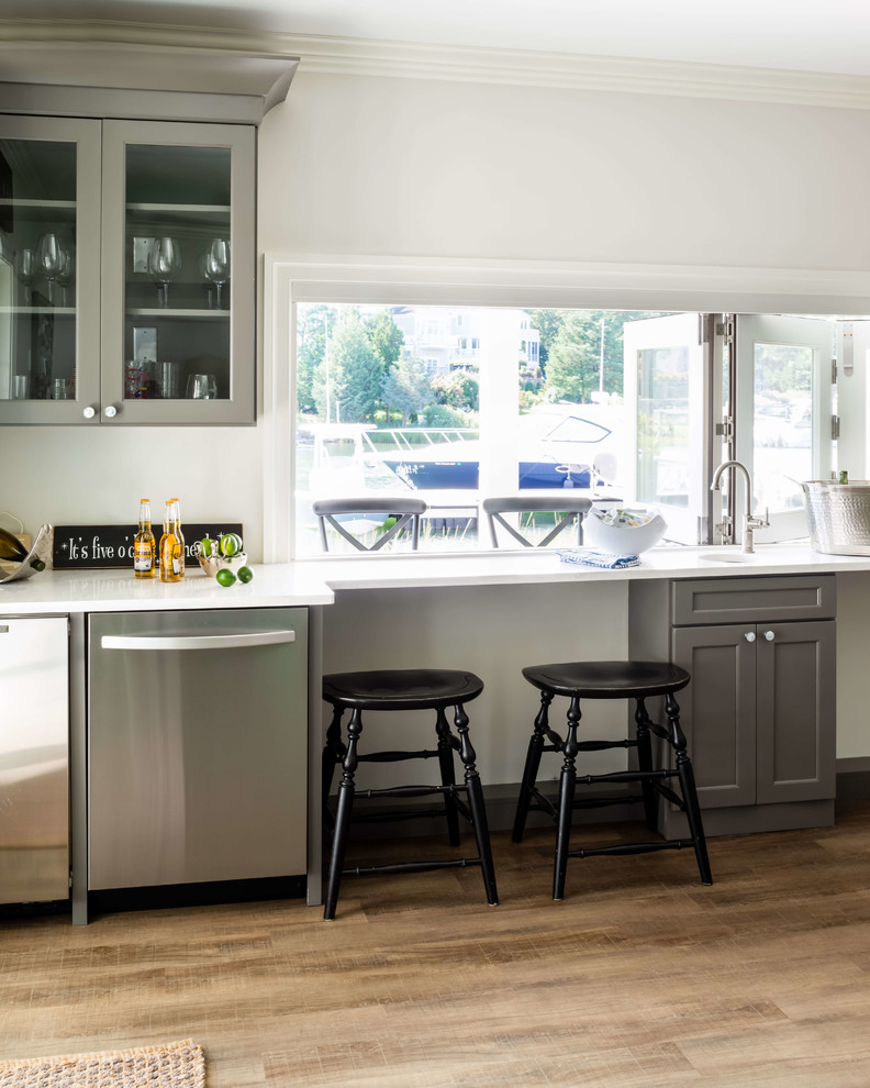Eat-in kitchen - l-shaped eat-in kitchen idea in Providence with white cabinets, quartzite countertops, stainless steel appliances and an island