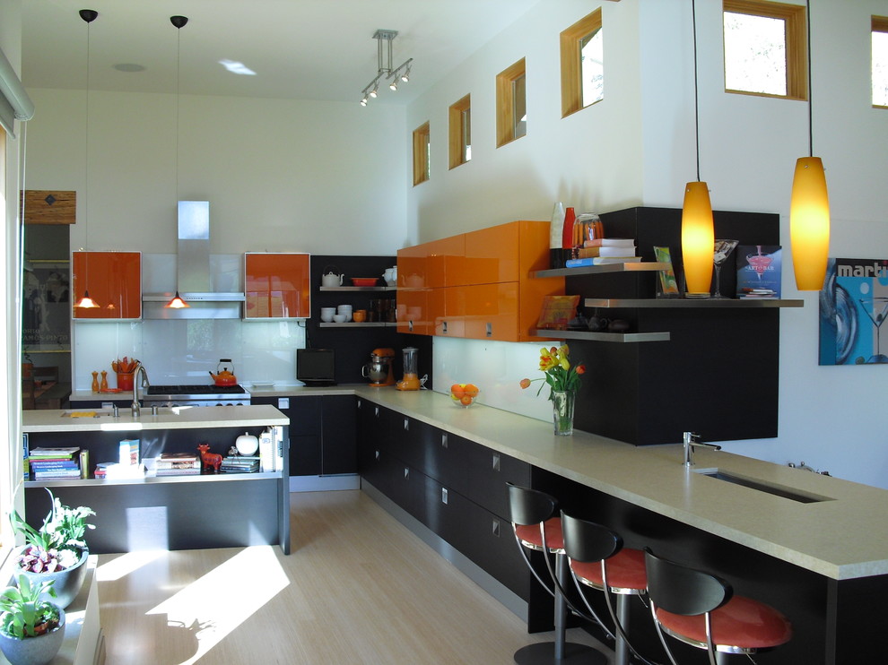 Design ideas for a large contemporary u-shaped open plan kitchen in San Francisco with a submerged sink, flat-panel cabinets, orange cabinets, engineered stone countertops, white splashback, glass sheet splashback, stainless steel appliances, bamboo flooring and an island.