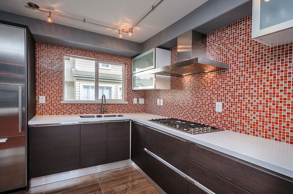 Inspiration for a mid-sized contemporary l-shaped eat-in kitchen remodel in San Francisco with an integrated sink, flat-panel cabinets, dark wood cabinets, quartz countertops, orange backsplash, mosaic tile backsplash, stainless steel appliances and an island