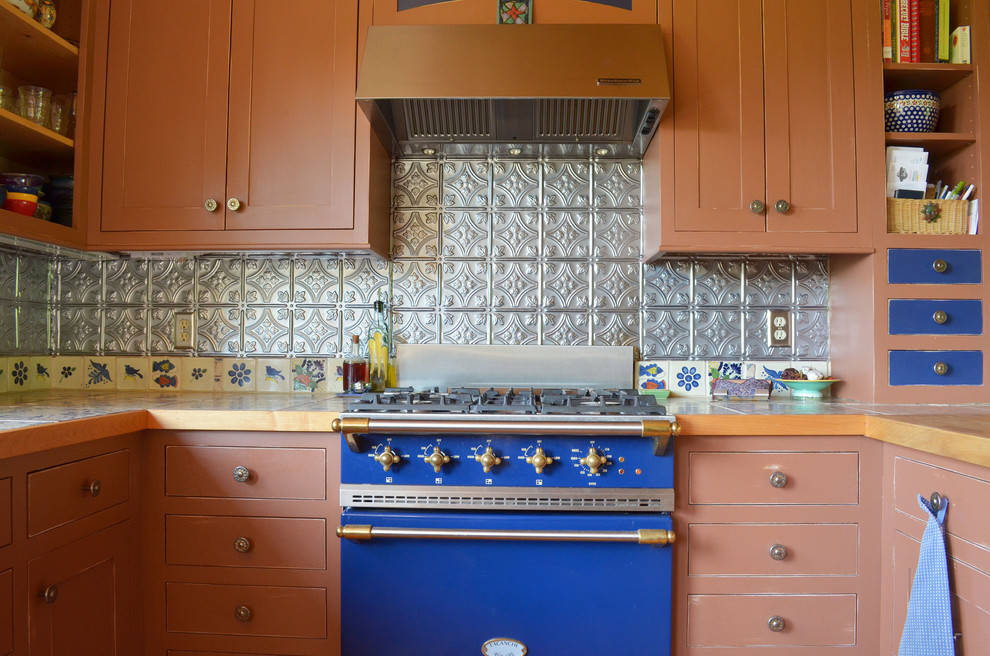Inspiration for a rustic kitchen remodel in Boise with metal backsplash, colored appliances, tile countertops, metallic backsplash and shaker cabinets