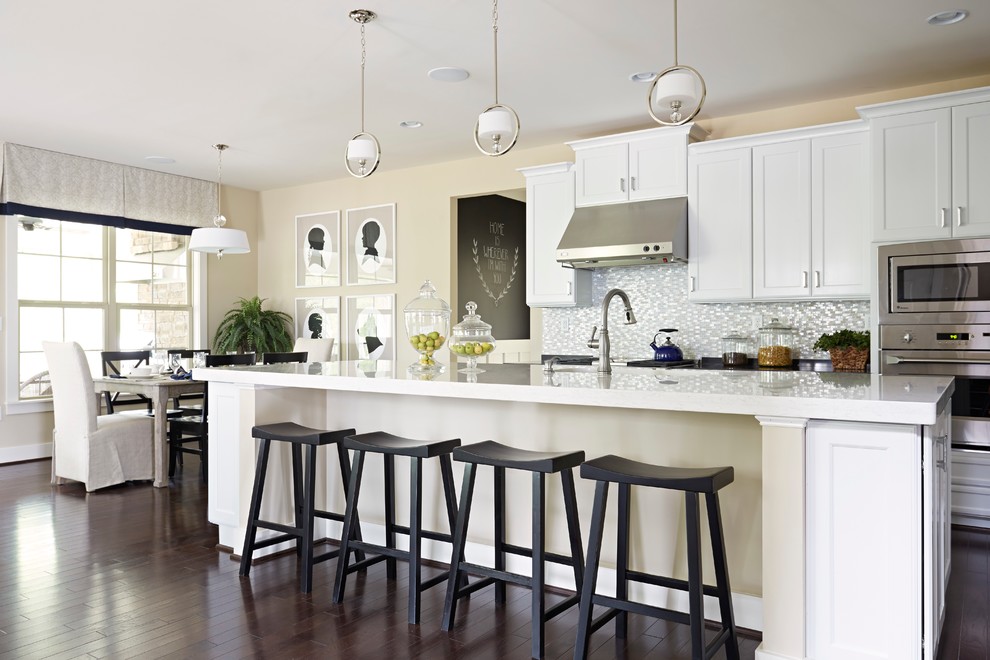 Inspiration for a classic kitchen/diner in Richmond with recessed-panel cabinets, white cabinets, grey splashback, mosaic tiled splashback and an island.