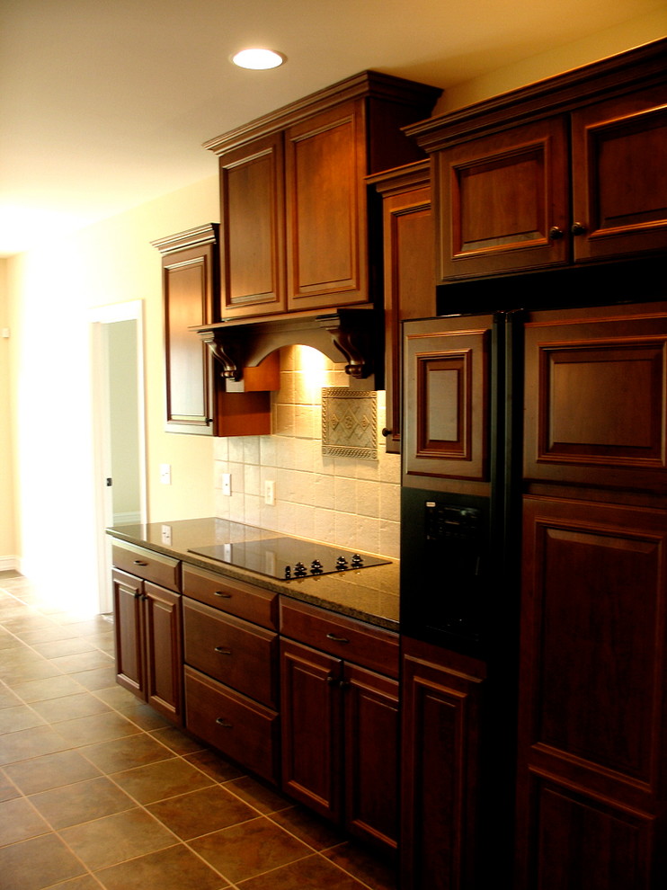 Example of a mid-sized classic l-shaped ceramic tile eat-in kitchen design in Other with a double-bowl sink, medium tone wood cabinets, granite countertops, multicolored backsplash, mosaic tile backsplash, stainless steel appliances, an island and raised-panel cabinets