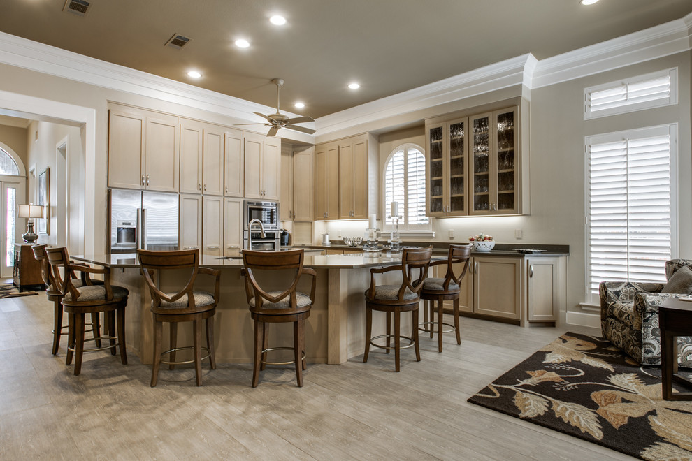 Example of a large minimalist l-shaped light wood floor open concept kitchen design in Dallas with a double-bowl sink, shaker cabinets, light wood cabinets, solid surface countertops, black backsplash, stone slab backsplash, stainless steel appliances and an island