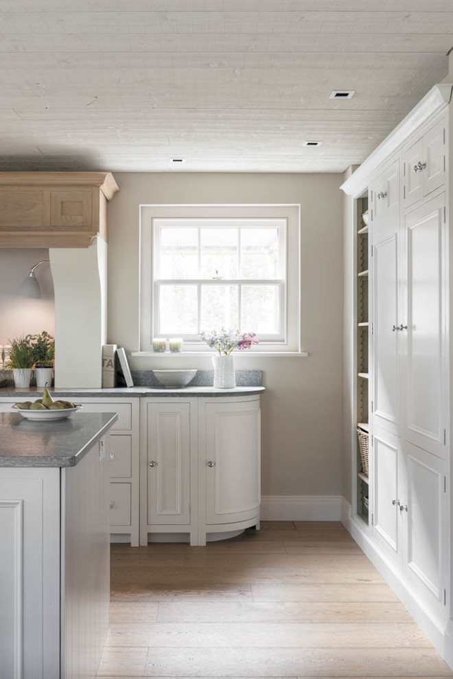 Inspiration for a country open plan kitchen in Hampshire with light hardwood flooring.