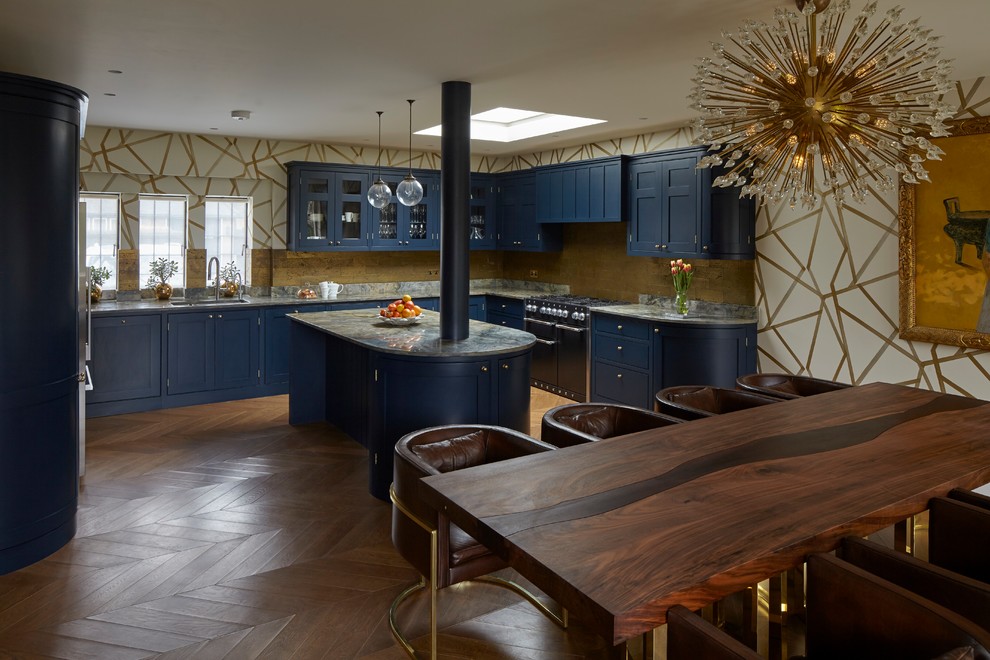 Design ideas for a large classic u-shaped kitchen/diner in London with blue cabinets, granite worktops, an island, brown floors, a submerged sink, glass-front cabinets, metallic splashback, black appliances, dark hardwood flooring and multicoloured worktops.