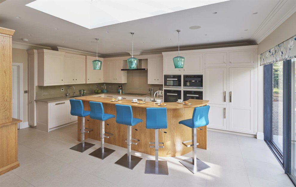 Inspiration for a large classic l-shaped kitchen/diner in Surrey with a single-bowl sink, shaker cabinets, quartz worktops, stainless steel appliances and an island.