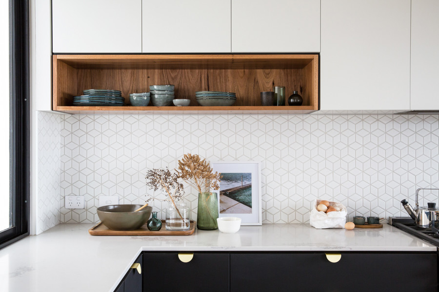 Inspiration for a large urban l-shaped kitchen pantry in Other with a single-bowl sink, flat-panel cabinets, black cabinets, composite countertops, white splashback, ceramic splashback, black appliances, concrete flooring, an island, grey floors and white worktops.