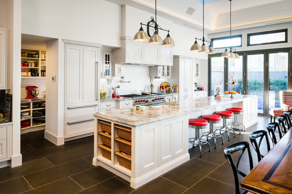 Kitchen - huge traditional porcelain tile and gray floor kitchen idea in Melbourne with a farmhouse sink, white cabinets, granite countertops, white backsplash, an island, subway tile backsplash, shaker cabinets, stainless steel appliances and multicolored countertops