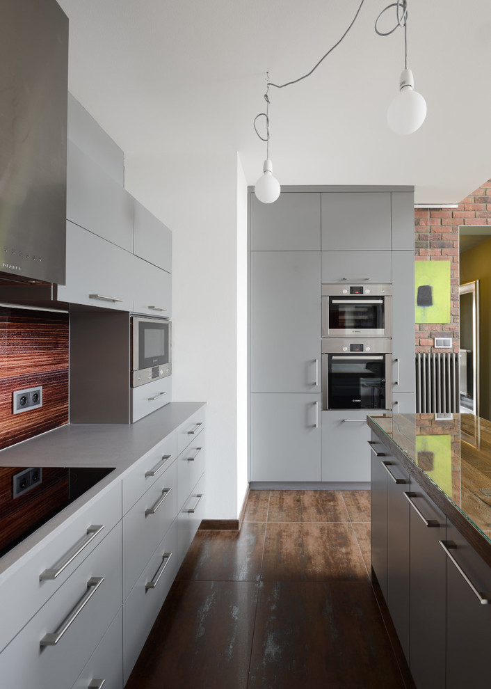 Example of an urban eat-in kitchen design in Other with gray cabinets and gray backsplash
