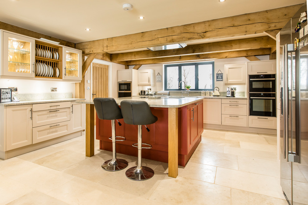 Inspiration for a large farmhouse u-shaped kitchen in Hampshire with beige cabinets, quartz worktops, stainless steel appliances, an island, beige floors, grey worktops and recessed-panel cabinets.