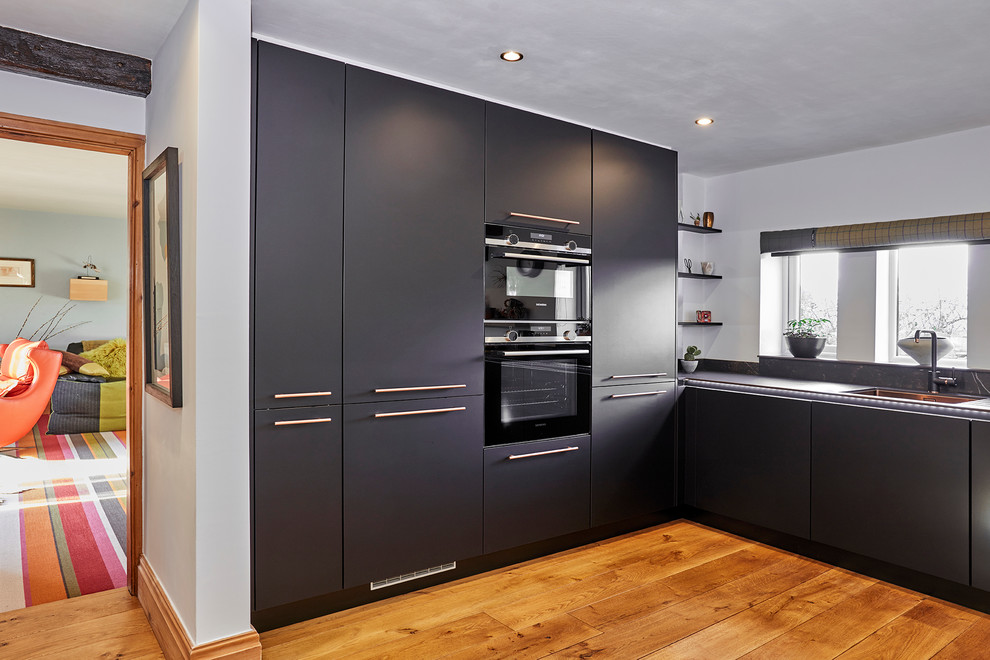 Handle Less Black Kitchen With Copper Accents Bespoke Concrete Breakfast Bar Modern Kitchen Other By Arlington Interiors