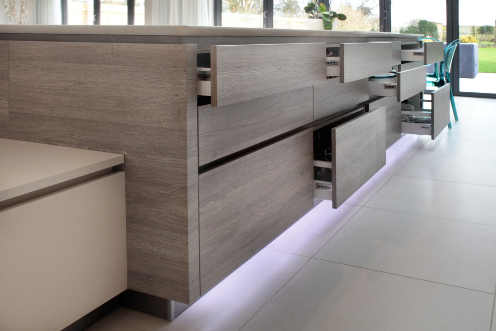 Handleless matt cashmere & grey wood effect kitchen with variety of