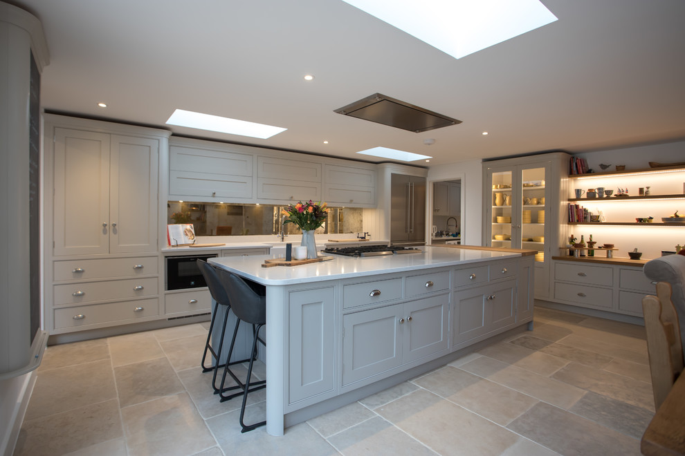 Inspiration for a huge timeless u-shaped limestone floor and beige floor eat-in kitchen remodel in Hertfordshire with a farmhouse sink, shaker cabinets, gray cabinets, quartzite countertops, metallic backsplash, mirror backsplash, stainless steel appliances, an island and yellow countertops