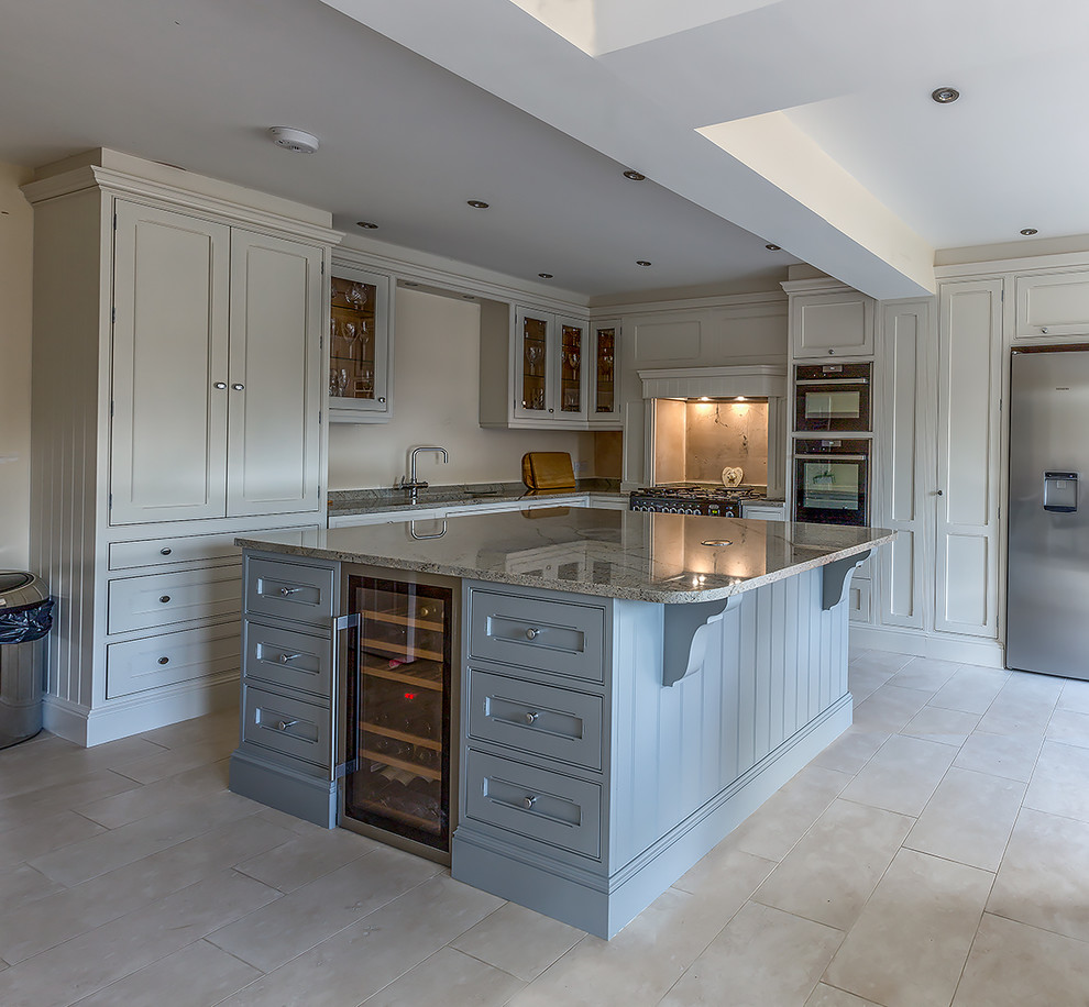 Medium sized traditional kitchen/diner in Cheshire with a built-in sink, shaker cabinets, beige cabinets, granite worktops, beige splashback, glass sheet splashback, integrated appliances, ceramic flooring and an island.
