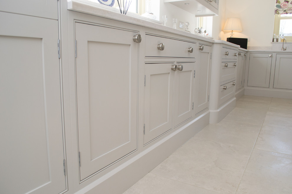 Inspiration for a large traditional u-shaped kitchen/diner in Other with a double-bowl sink, shaker cabinets, grey cabinets, quartz worktops, white splashback, ceramic splashback, integrated appliances, porcelain flooring, an island and grey floors.