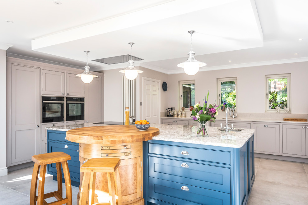 Inspiration for a classic u-shaped kitchen/diner in Hampshire with a submerged sink, shaker cabinets, grey cabinets, granite worktops, black appliances, an island, grey floors and grey worktops.