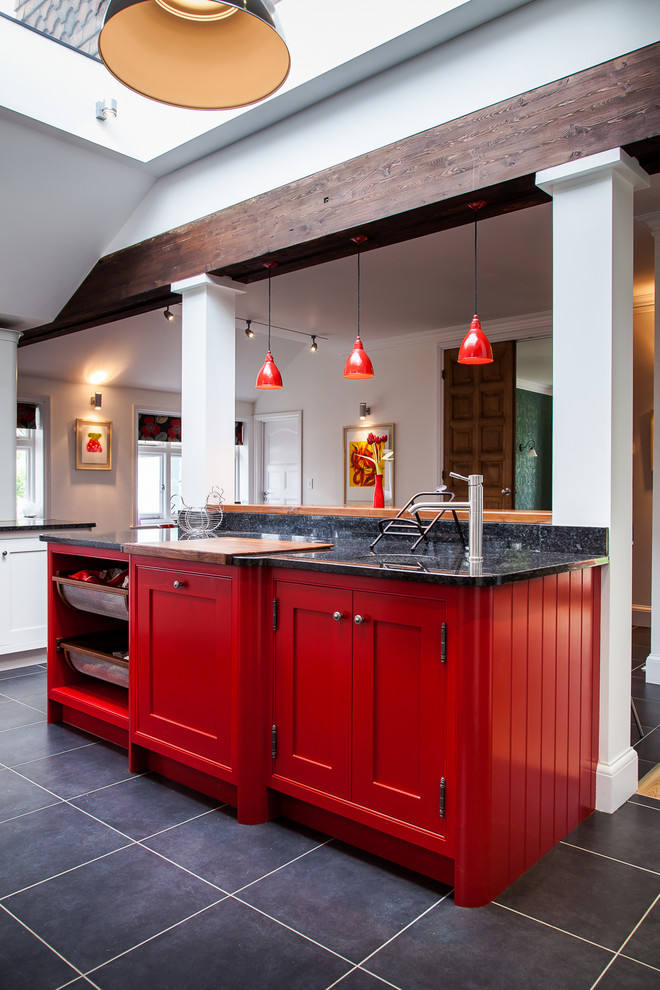Inspiration for a large cottage ceramic tile enclosed kitchen remodel in Hertfordshire with an undermount sink, shaker cabinets, red cabinets, granite countertops, ceramic backsplash, stainless steel appliances and an island